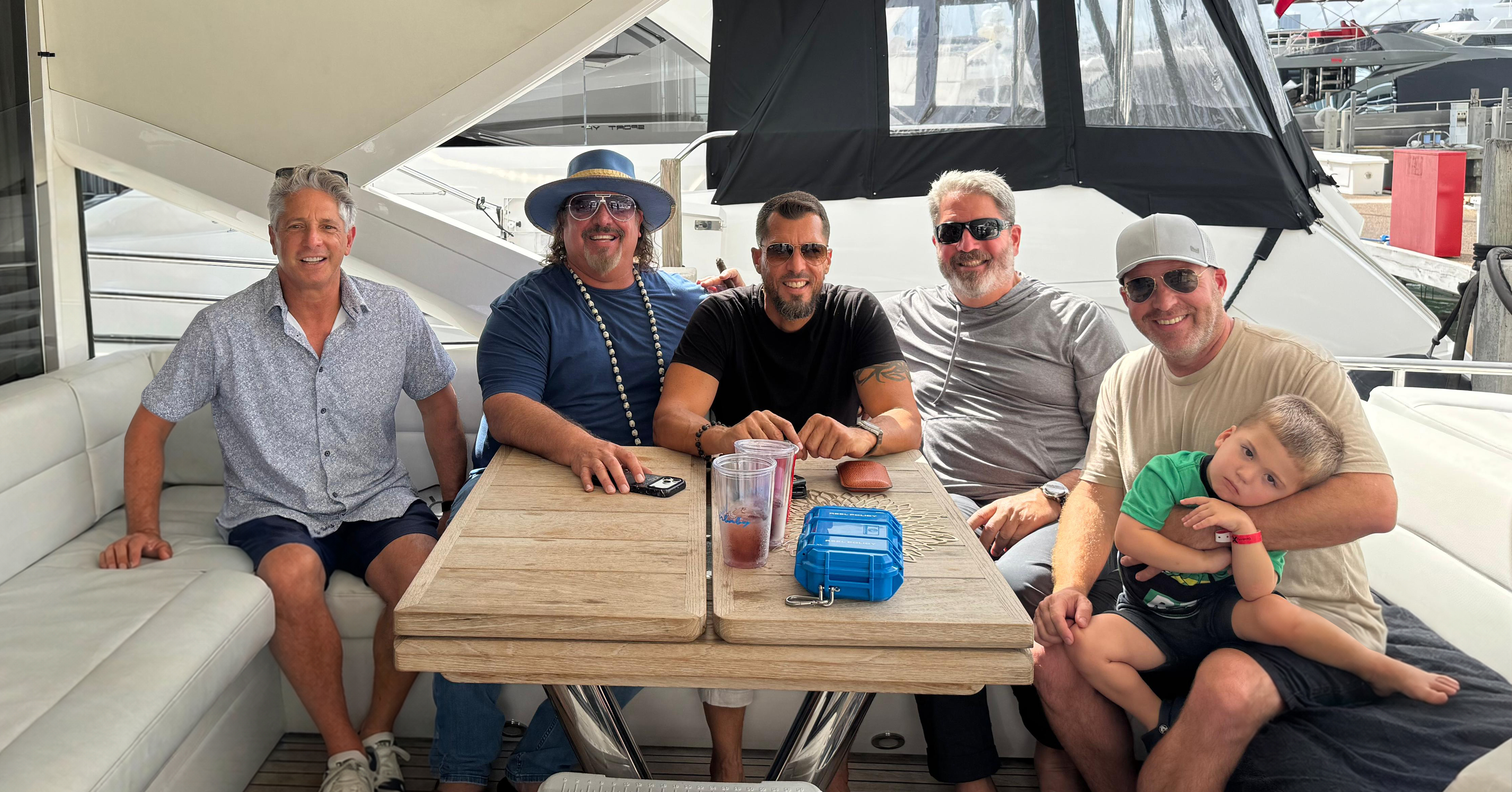 Friends relaxing inside luxury yacht cabin